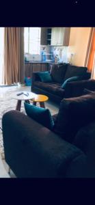 a living room with couches and a coffee table at Brooks apartments in Kampala