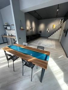 a ping pong table with two chairs in a room at Promenade Burabay halal-apartments (no alcohol, no unmarried couples)) in Borovoye