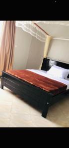 a bed in a room with at Brooks apartments in Kampala