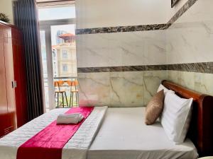 a bedroom with a bed with a red blanket at kim'hotel near SECC - FV in Ho Chi Minh City +16 photos