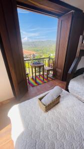a bedroom with a bed and a large window with a table at Casa campestre mediterraneo in Barichara