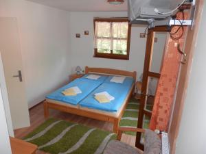 a bedroom with a blue bed in a room at Penzion Stárek in Terchová