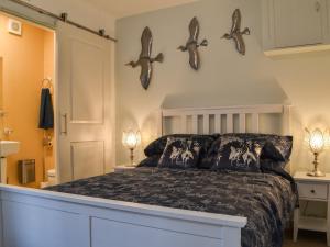 a bedroom with a bed with three fish hooks on the wall at Quayside7 in Whitehaven
