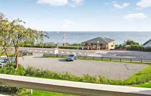 a car parked in a parking lot next to the ocean at 2 Bedroom Stunning Apartment In Allinge in Allinge