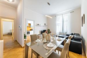 a dining room and living room with a table and chairs at Big bright two-bedroom apartment in Prague Old Town in Prague