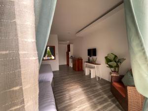 a living room with a couch and a window at Bella Napoli Resort & Resto in Panglao Island