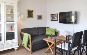 a living room with a couch and a table at Beautiful Apartment In Vejers Strand With 1 Bedrooms And Wifi in Vejers Strand