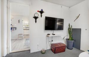 a living room with a clock on a wall at Pet Friendly Home In Roslev With Wifi in Roslev