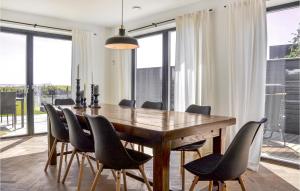 a dining room with a wooden table and chairs at 4 Bedroom Lovely Home In Dragr in Dragør