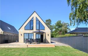 a house with a triangular roof with a lawn at Beautiful Home In Dragr With 4 Bedrooms And Wifi in Dragør