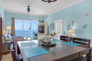 a dining room with a table with a view of the ocean at Ocean Villa Penthouse #2302 in Panama City Beach