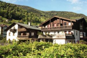 a large house with a mountain in the background at Enzian 13 - Sonnige von Bad Kleinkirchheim in Bad Kleinkirchheim