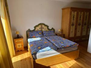 a bedroom with a bed with a blue comforter at Enzian 13 - Sonnige von Bad Kleinkirchheim in Bad Kleinkirchheim