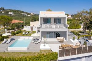 an aerial view of a house with a swimming pool at Villa Nick Art in Lithakia