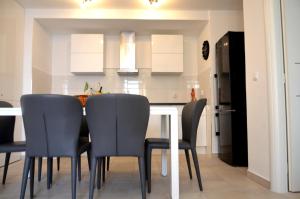 a kitchen with a dining room table and chairs at Apartment Chic Ploce in Dubrovnik