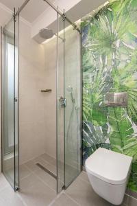a bathroom with a glass shower with a toilet at Villa Nick Art in Lithakia