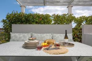 a table with plates of food and a bottle of wine at Villa Nick Art in Lithakia