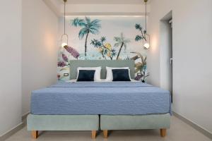 a bedroom with a blue bed with a painting on the wall at Villa Nick Art in Lithakia +45 photos