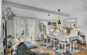 a dining room with a white table and chairs at Beautiful Home In Højby With Wifi in Højby