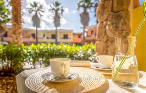 a table with two coffee cups and a vase at Mono 2 in Palau
