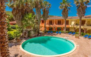 a swimming pool in front of a house with palm trees at Mono 2 in Palau +8 photos