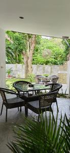 eine Gruppe von Tischen und Stühlen auf einer Terrasse in der Unterkunft Calao Villa, Solar Villa 2 rooms with Private Pool in El Nido