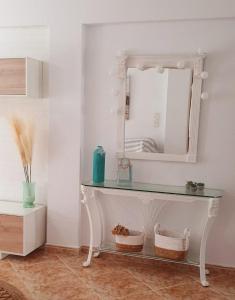 a white dressing table with a mirror on a wall at Monela Front beach in Playa de Gandia