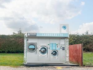 a washing machine is parked in a field at La Hacendia Lodge in Morpeth