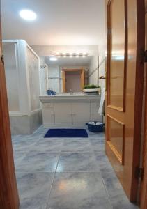 a bathroom with a sink and a large mirror at Monela Front beach in Playa de Gandia