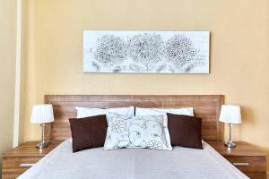 a bedroom with a large bed with two lamps at Espanhouse La Zenia 109 in Orihuela Costa +70 photos