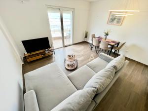 a living room with a white couch and a table at Nicolas 618 in Durrës