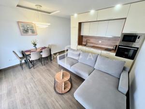 a living room with a couch and a table at Nicolas 618 in Durrës