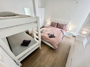 a bedroom with two bunk beds with pink sheets at Nicolas 618 in Durrës