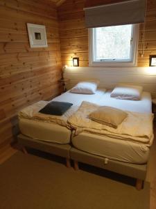 two twin beds in a room with a window at "Au Cha les Vaux" Chalet 49 in Mauroux +31 photos