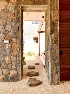 an entrance to a stone building with rocks in the doorway at Into the Sun - Modern Holiday Home in Albion