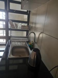 a kitchen sink with a faucet in a kitchen at Oasis comfort in Nairobi