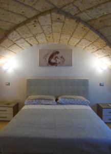sypialnia z niebieskim łóżkiem w pokoju w obiekcie Glem Luxury w mieście Copertino +19 zdjęć