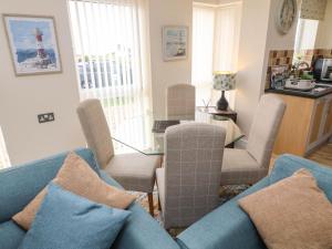 a living room with a blue couch and chairs at Apartment 1 in Morecambe