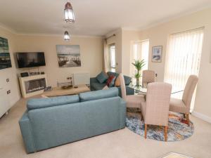 a living room with a couch and a table at Apartment 1 in Morecambe