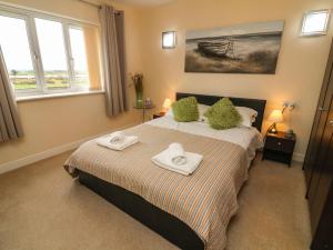 a bedroom with a bed with towels on it at Apartment 1 in Morecambe