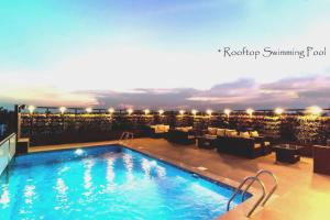 a swimming pool on the roof of a hotel at Roopa Elite in Mysore