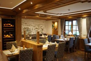 a restaurant with tables and chairs and a mural at Naturparkhotel Schwarzwaldhaus in Bernau im Schwarzwald