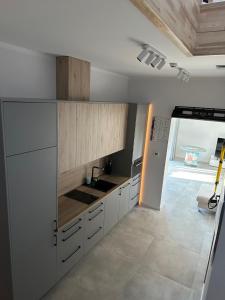 a kitchen with white cabinets and a sink at Atpuutas māja pie Jūras-Riņķi in Saulkrasti