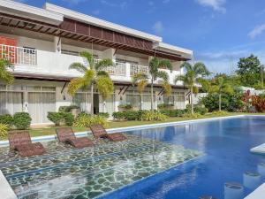a swimming pool in front of a building at Bella Napoli Resort & Resto in Panglao Island
