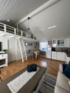 a large kitchen and living room with a ladder at Lofotbua in Offersøya