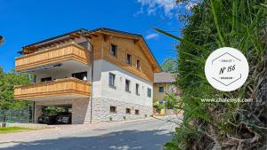 a large house with a balcony on the side of a road at Appartement Chalet N° 156 Wagrain in Wagrain