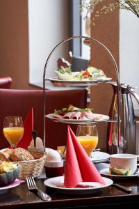 a table with plates of food and glasses of orange juice at Boutique Hotel am Markt in Melle