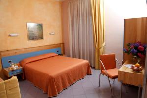 um quarto de hotel com uma cama, uma mesa e cadeiras em Hotel Diana em Pompeia