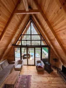 a room with a large window in a wooden cabin at Şile de Eşsiz Bungalov 2+1 Ev in Sile