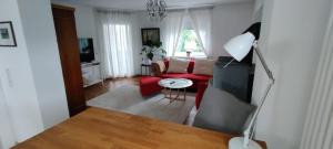 a living room with a red couch and a table at Apartment Lia in Beerfelden
